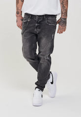 DESTROYED TAPERED FIT JEANS
